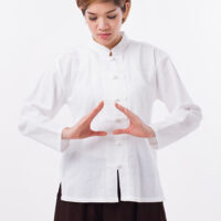 kaha-aroha peaceful, strong, confident asian woman practice kungfu qigong, solar plexus concentration